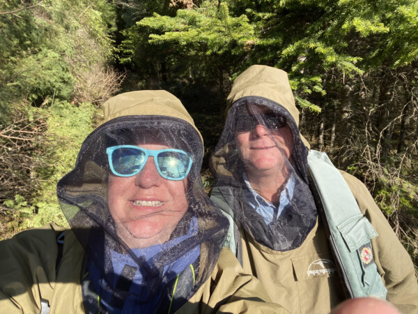 A couple hiking around Woman Lake Lodge Canada