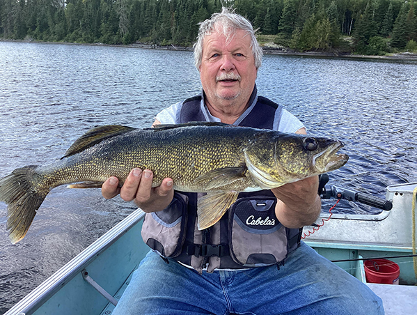 Greg Erickson holding a freshly caught fish at Woman Lake Lodge