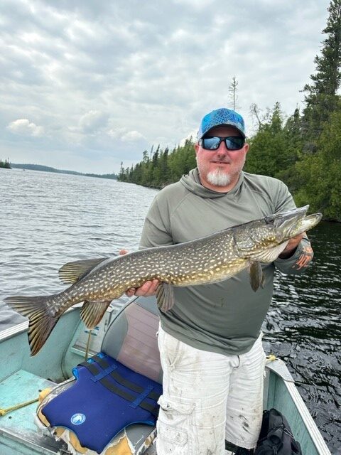 Matt catching a large fish at Woman Lake Lodge
